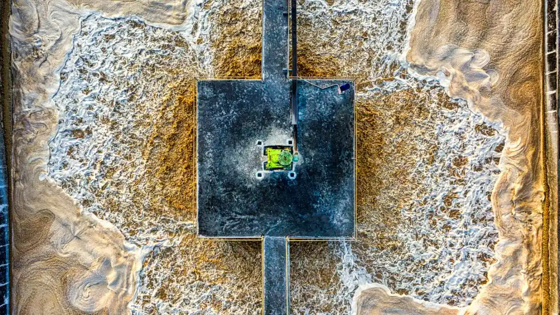 Aerial view of an aeration pond at a wastewater treatment facility